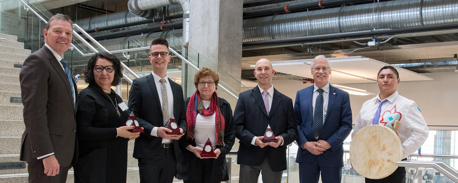 Faculty of Arts award winners poses with awards
