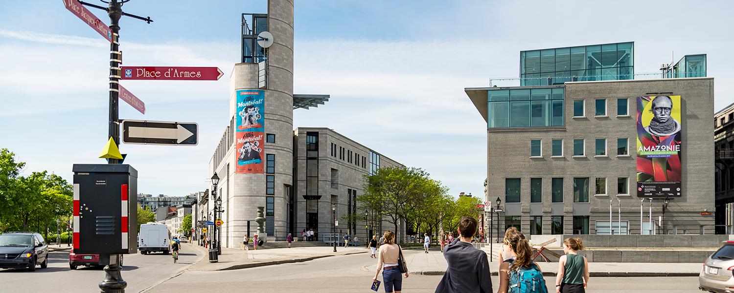 A stock photo of a montreal street scene. People are walking.