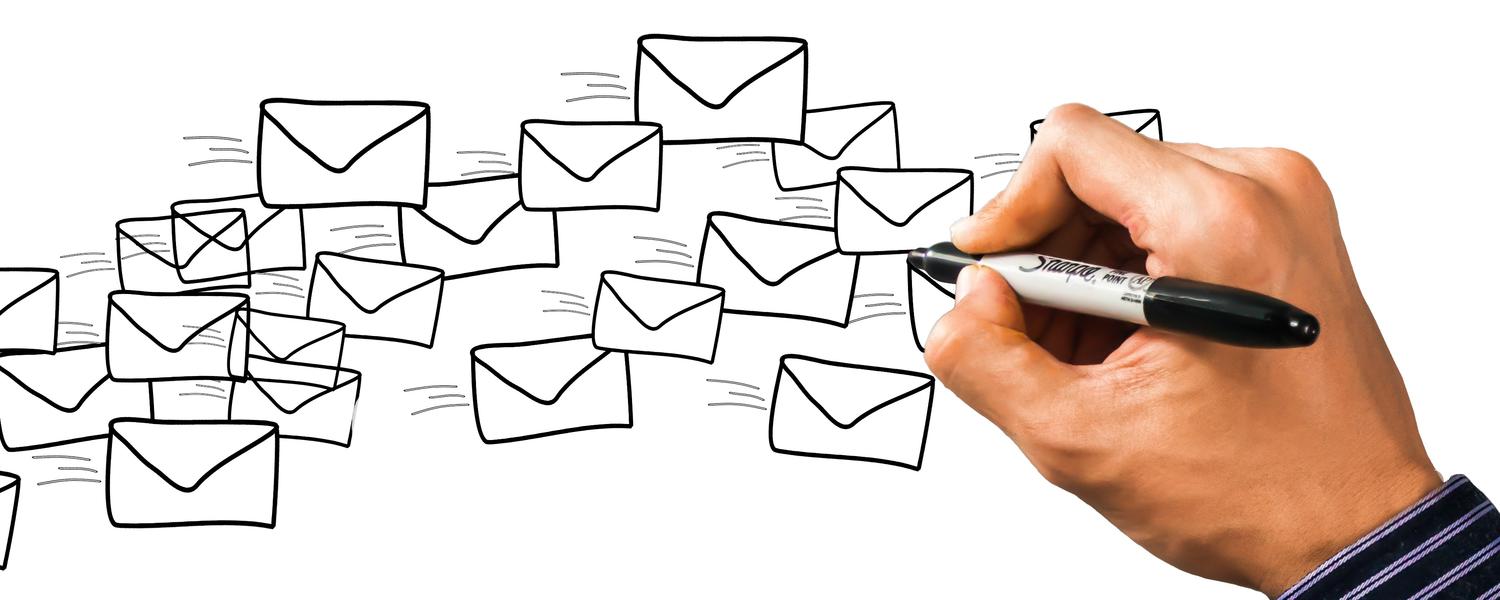 Hand holding sharpie drawing several envelopes in flight. This is probably how mailing lists work.