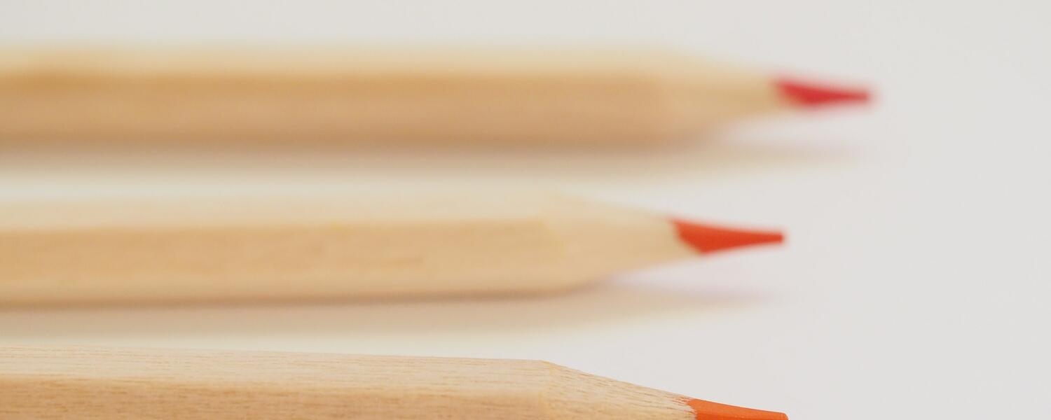 Coloured pencils in a row.