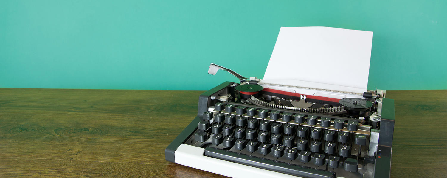 Typewriter with a teal background