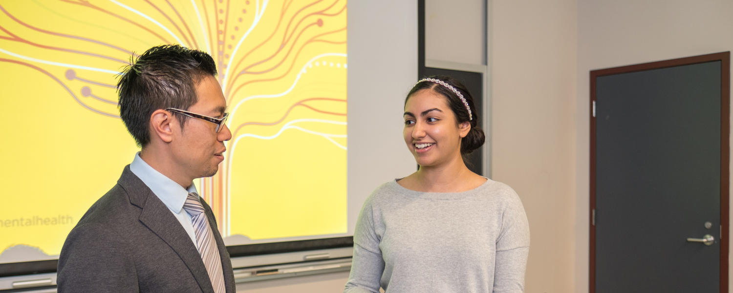 Director of Campus Mental Health Strategy Andrew Szeto talks to a student