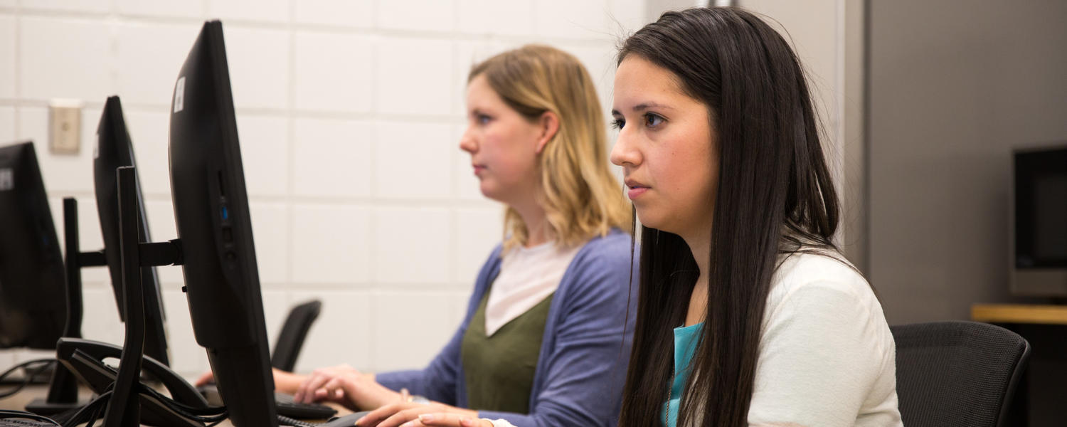 Students look at computers inside the clinic