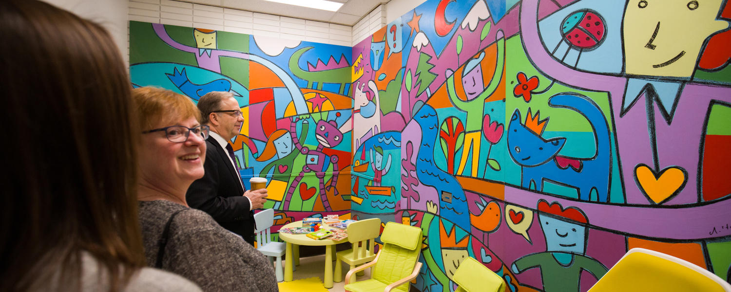 Donors are shown the children's play therapy room at the clinic opening event