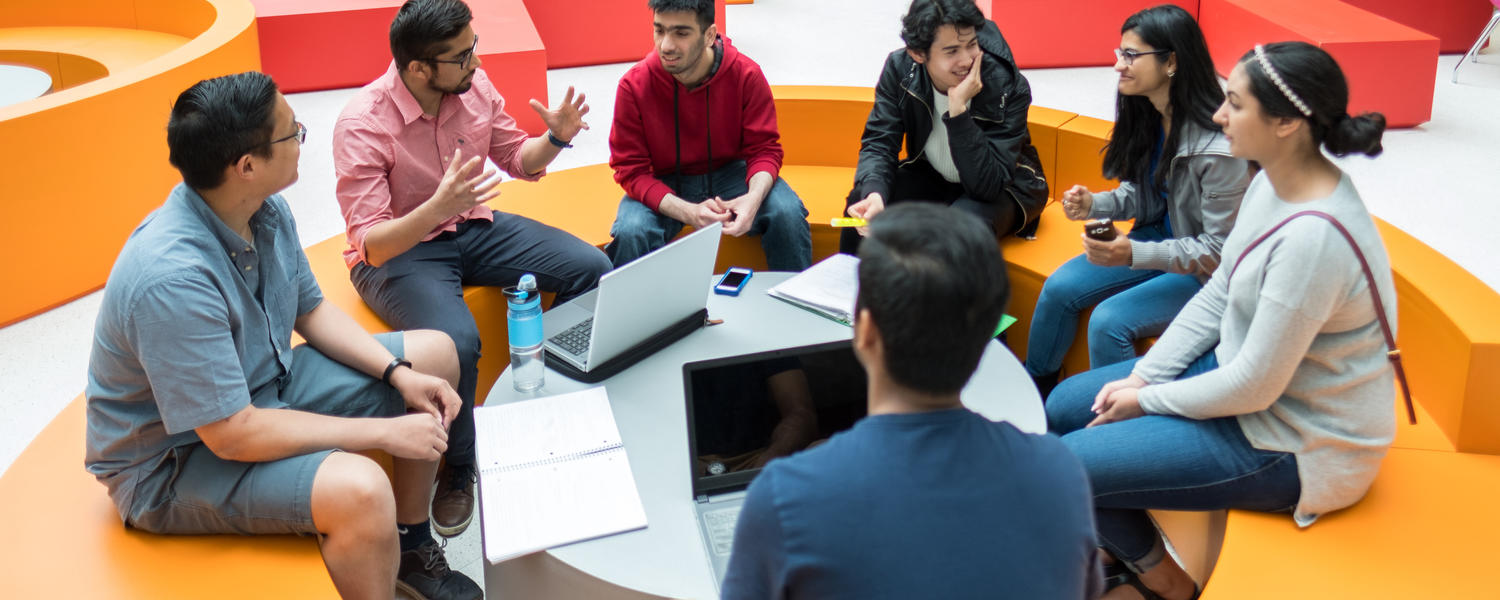 Students sitting around talking and working