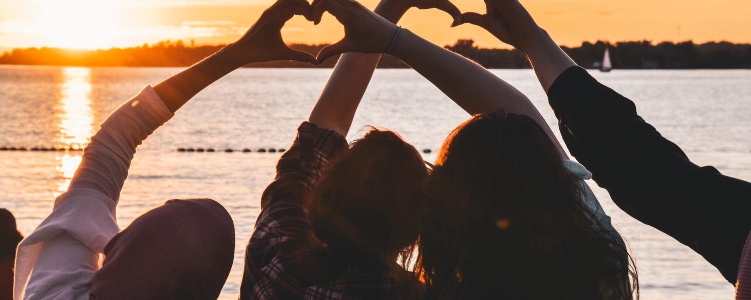 Friends making hearts with their hands 