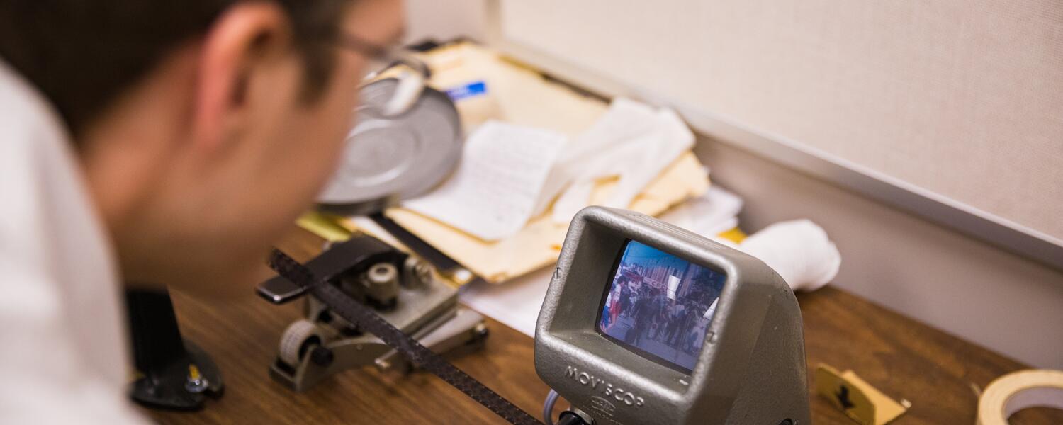 Professor Charles looking at a camera