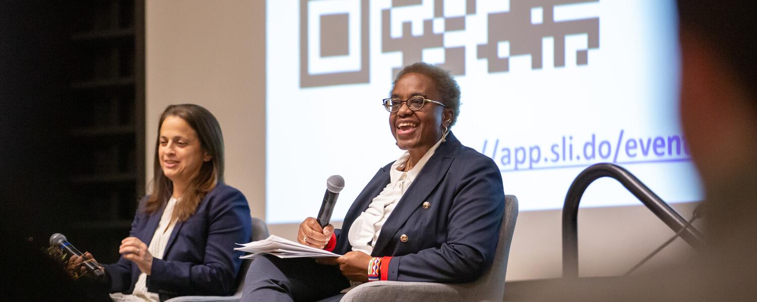 Malinda Smith at the podium giving a speech to the audience