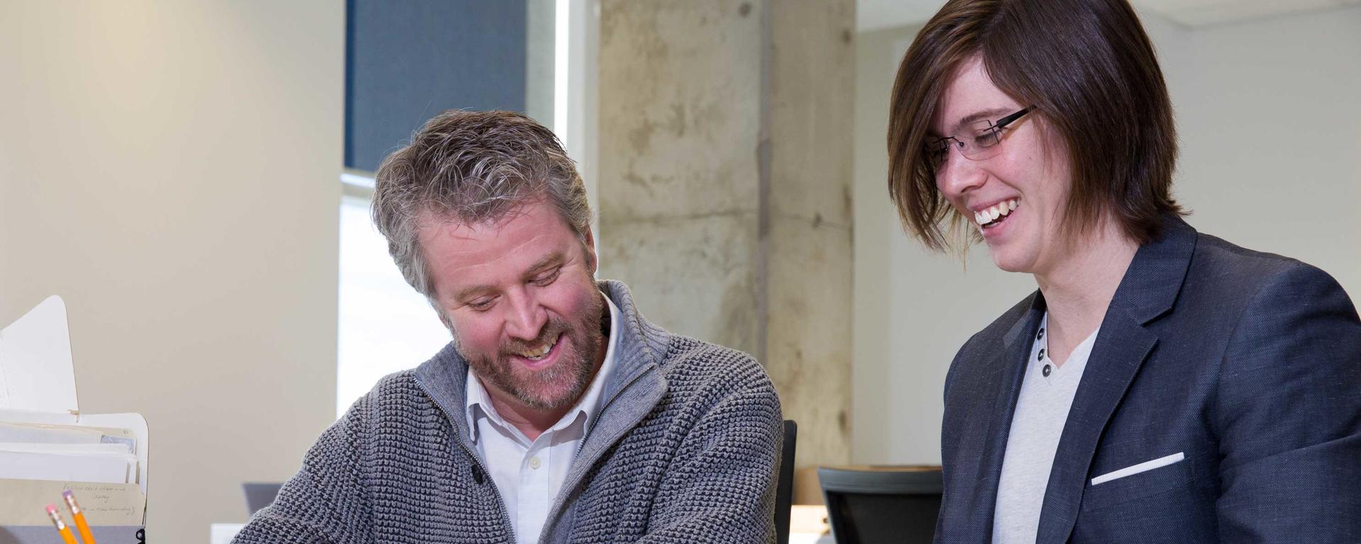English Professor Jason Wiens and PhD Student Jordan Bolay examine Guy Vanderhaeghe’s archives. 