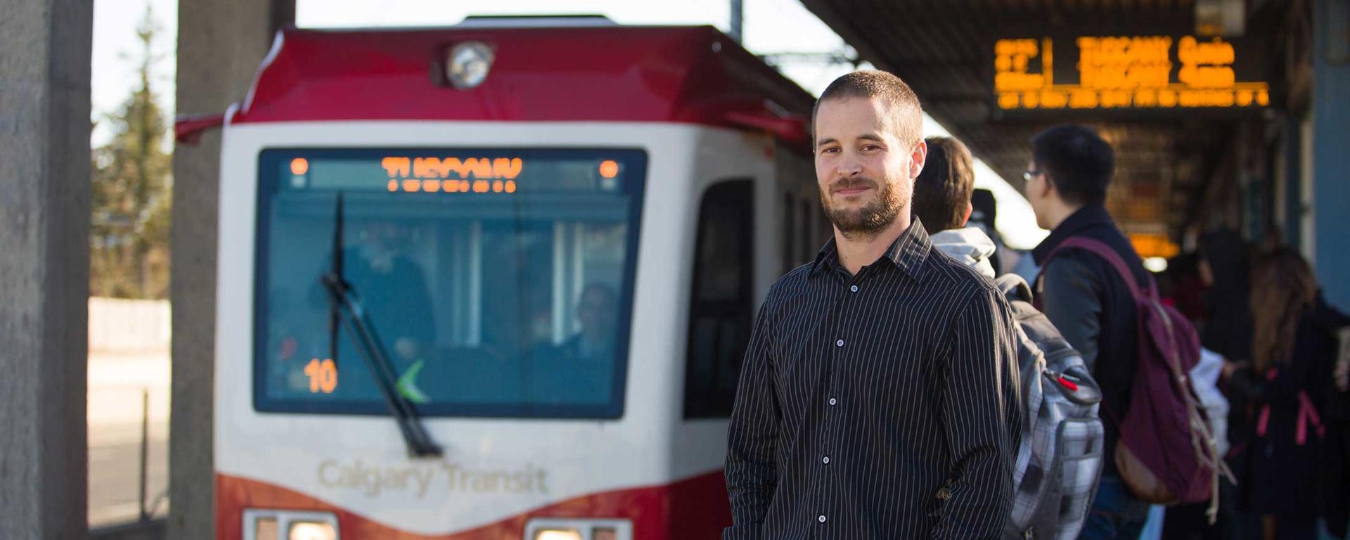 UCalgary Geography Graduate Student Mark Pfeifer stands on the platform at the University train station