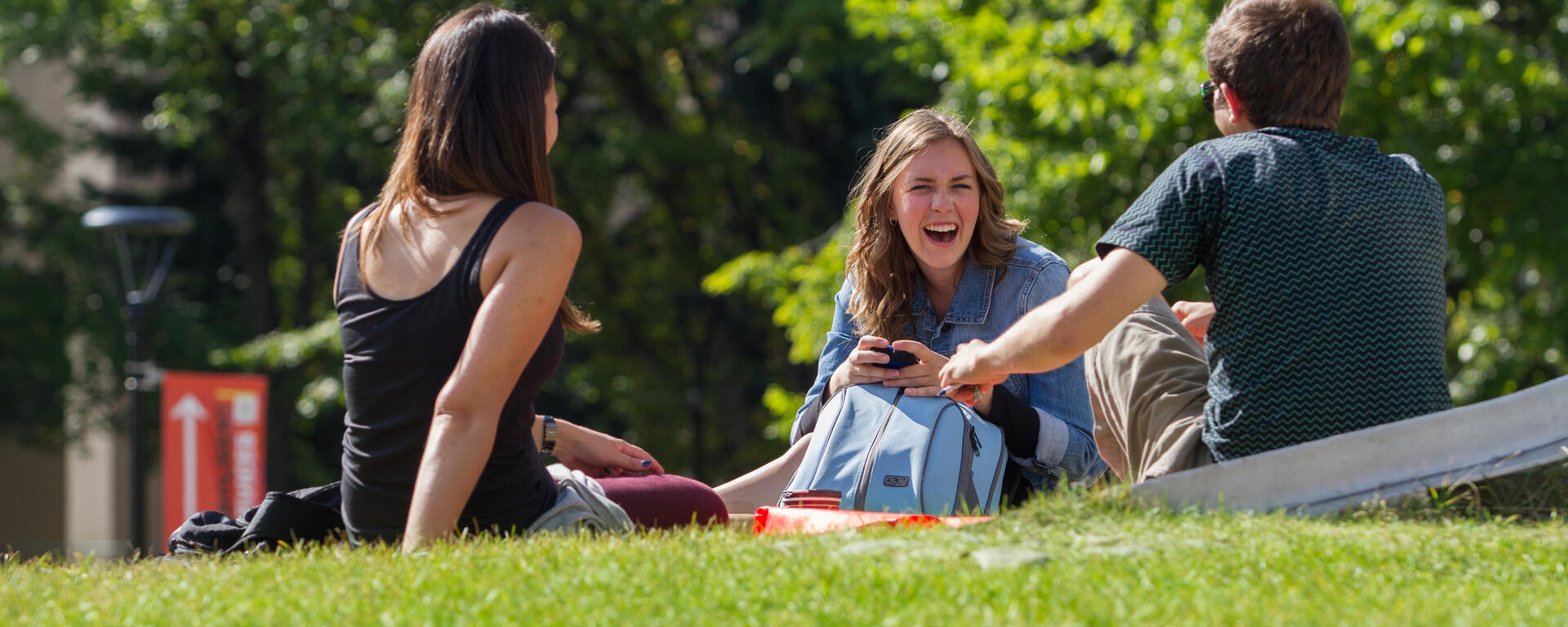 Students hanging out on a campus field