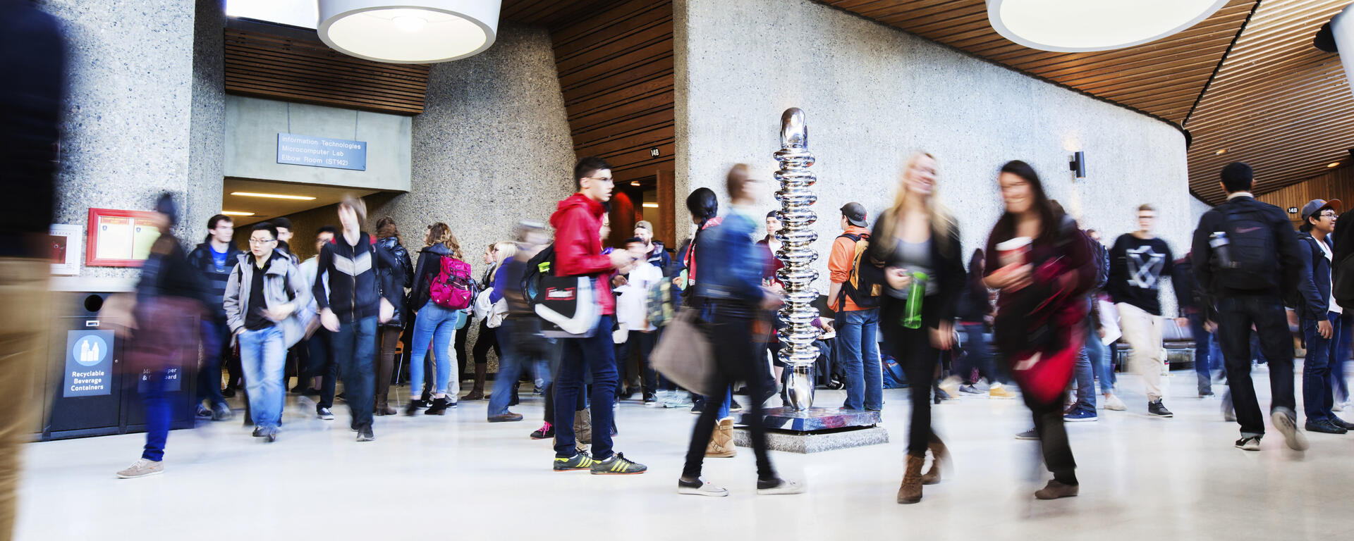An energetically crowded scene in Science Theatres as students move about between classes