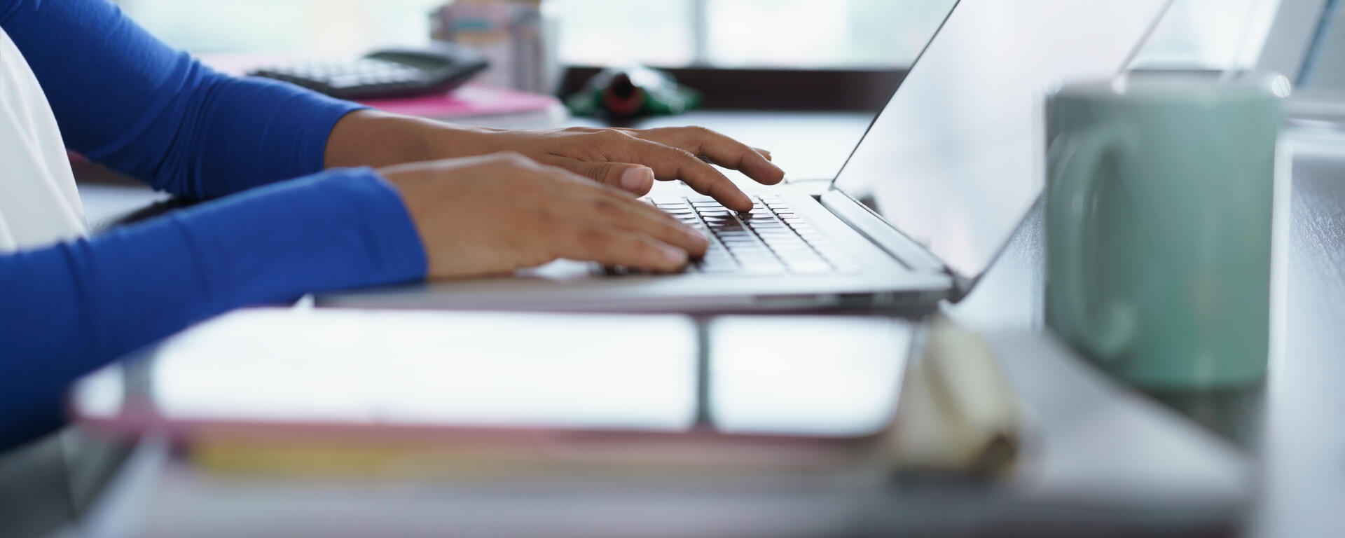 girls hand studying on laptop