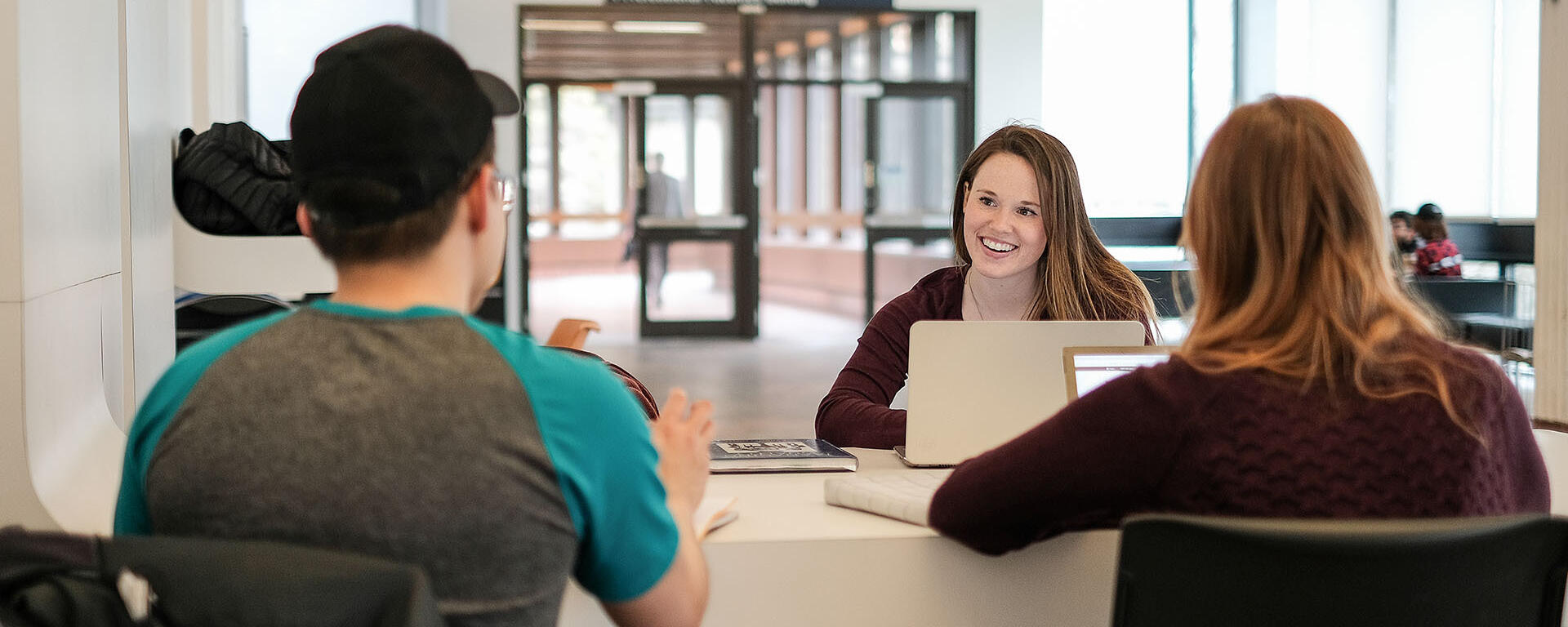 Student talking to each other at a desk