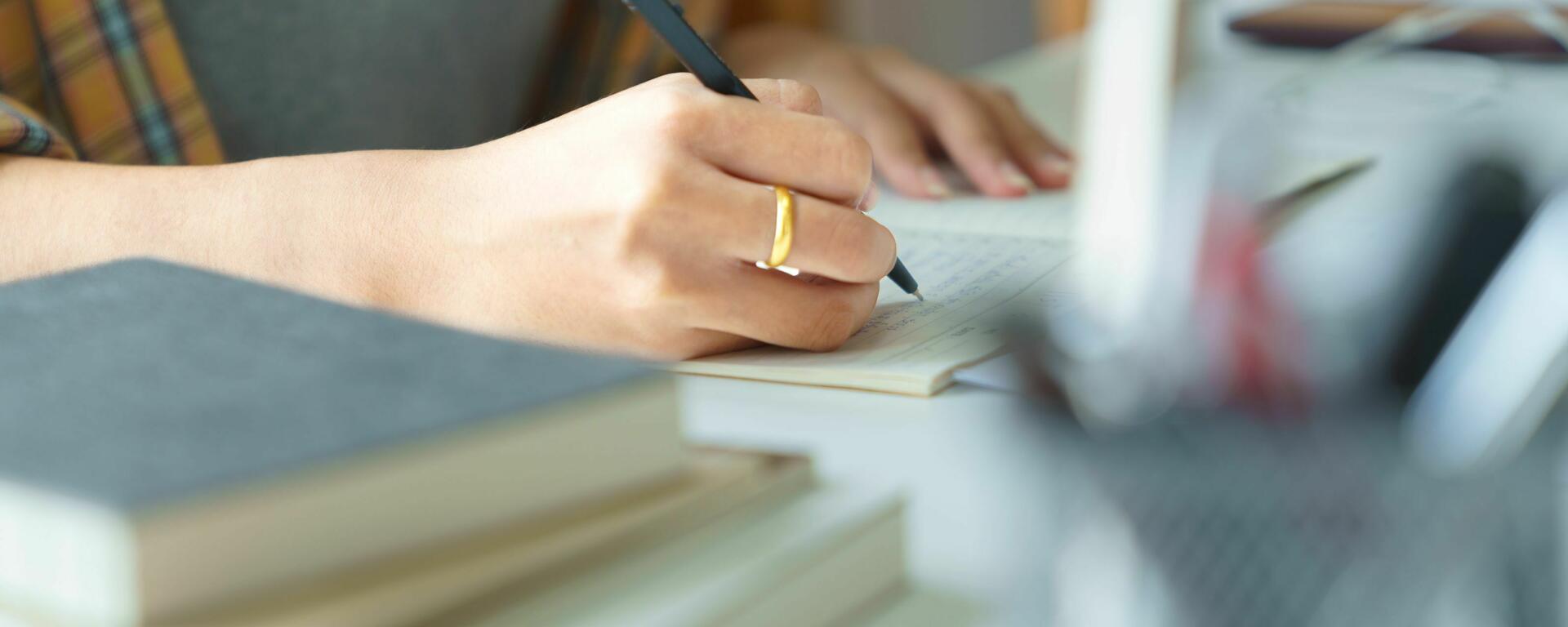 Student making notes on paper 