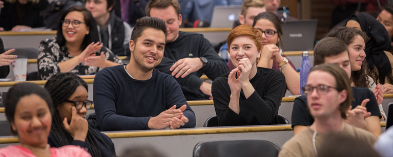 Federal Finance Minister William Francis "Bill" Morneau, speaks to political science students at the University of Calgary. Students sit smiling in the lecture theatre.