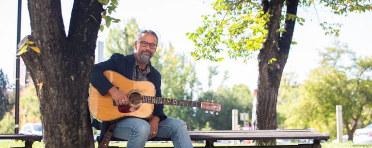 Person with guitar sitting