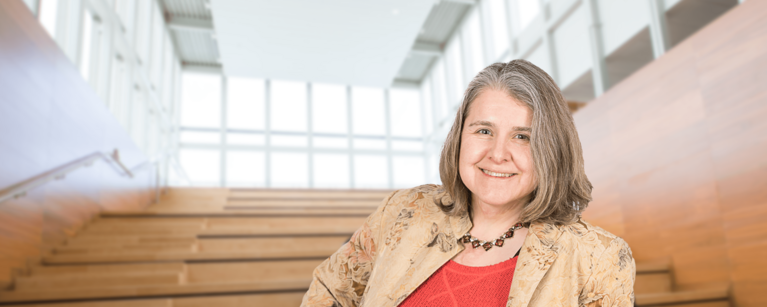 A lady in front of stairs