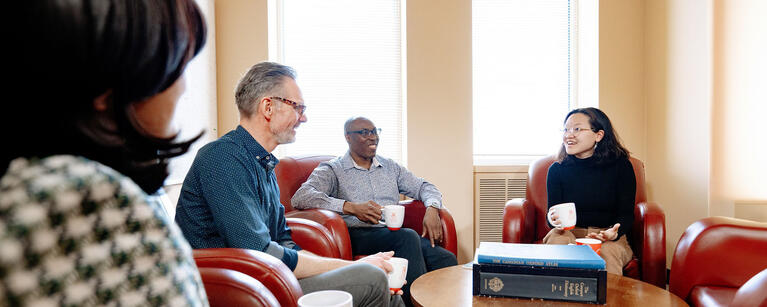 Colleagues in the English department chat in the lounge.