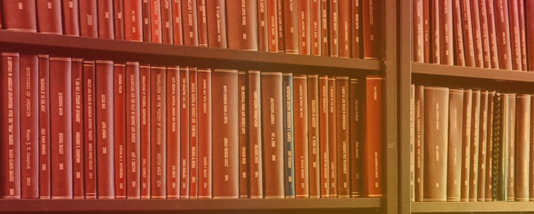 A bookshelf wall of thesis titles