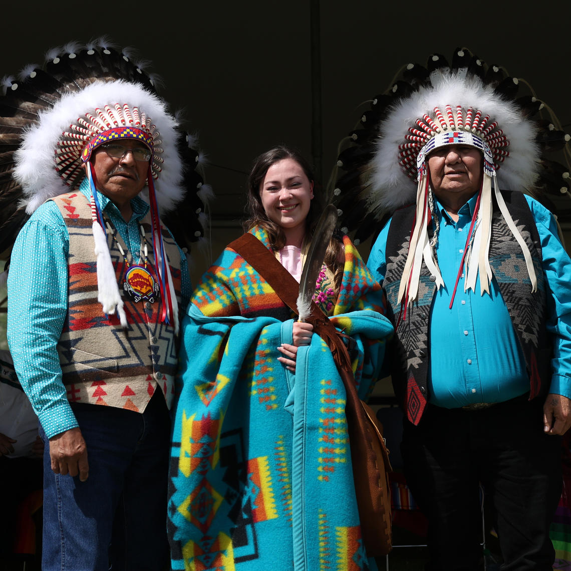 Elder Dr. Clarence Wolfleg, Lee Barrell, and Elder Dr. Reg Crowshoe at the 2022 UCalgary Indigenous Graduation Celebration