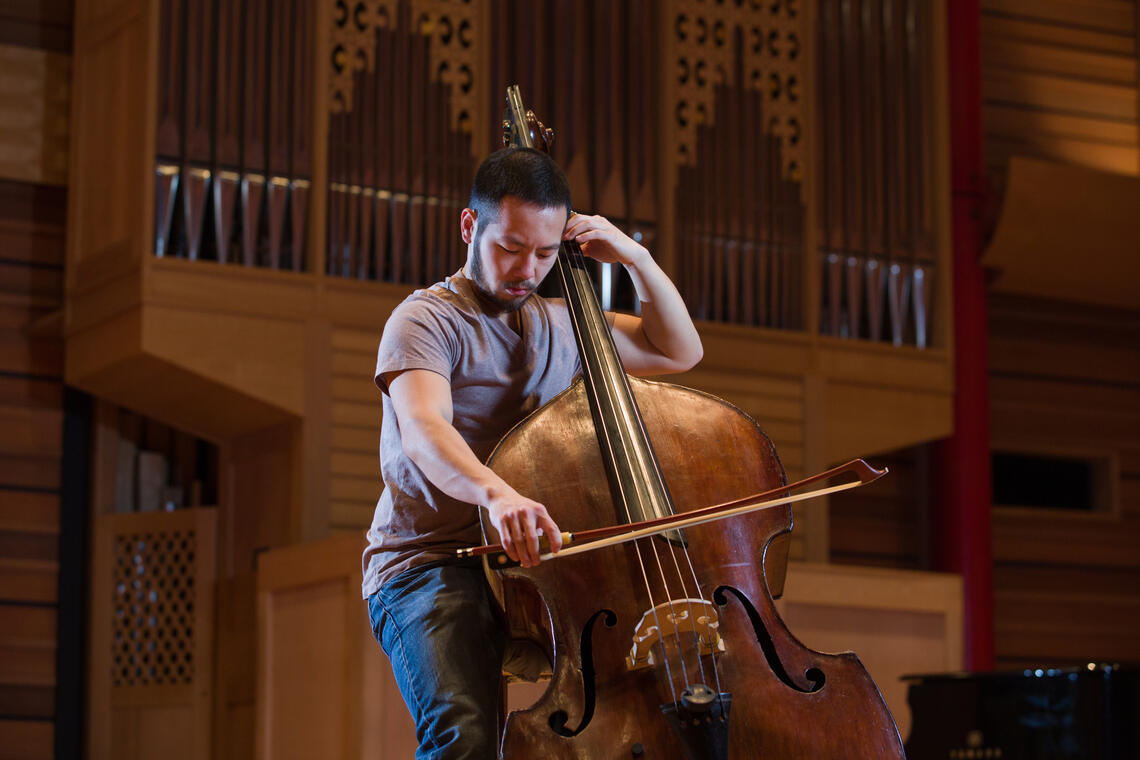 A man playing music instrument on a stage 