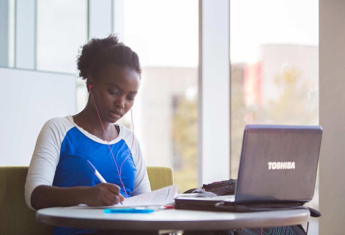 Student studies with laptop
