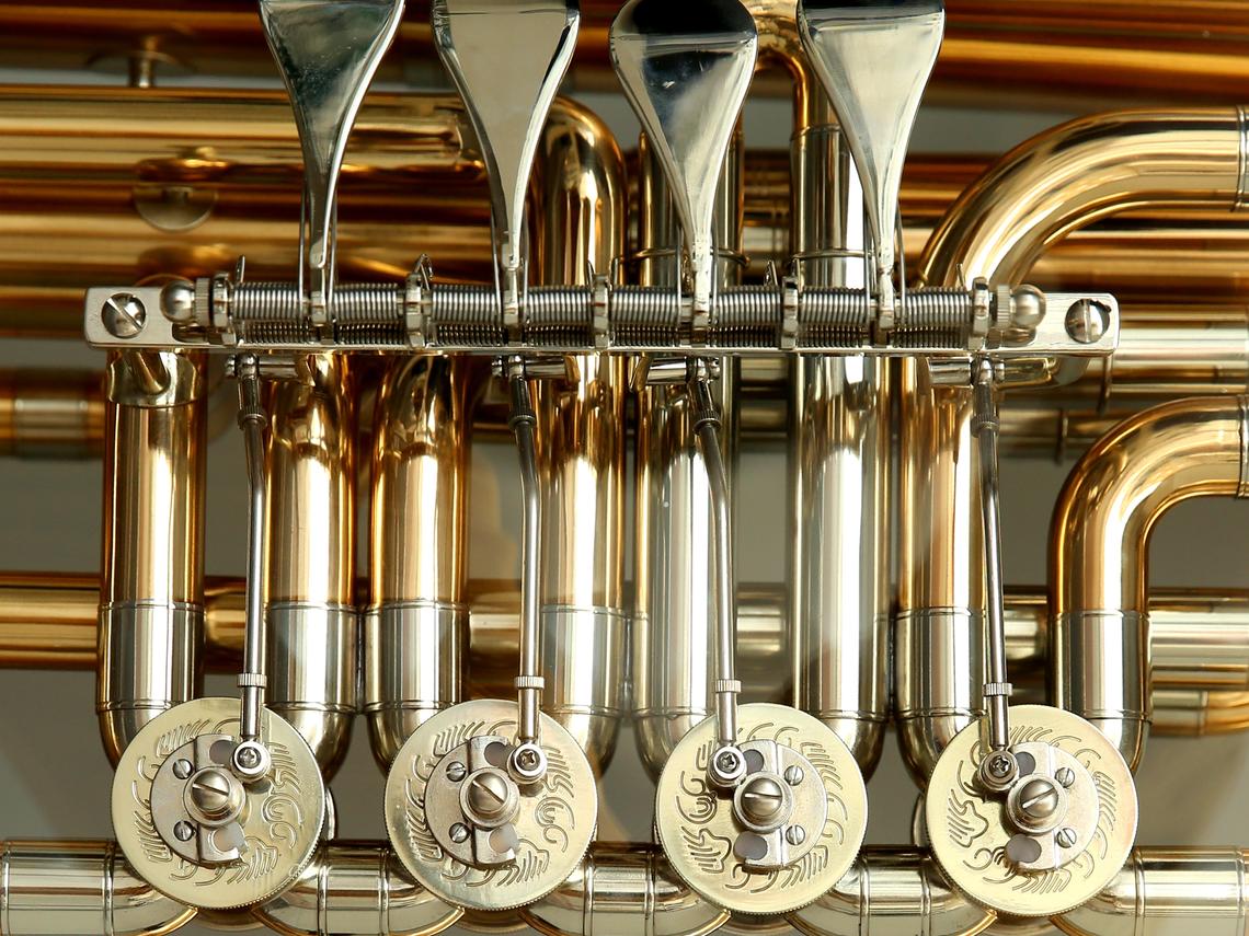 Closeup image of a the keys of a brass instrument