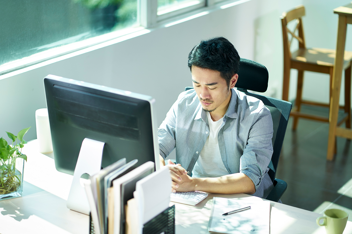 Stock photo: young asian entrepreneur contemplating in office 