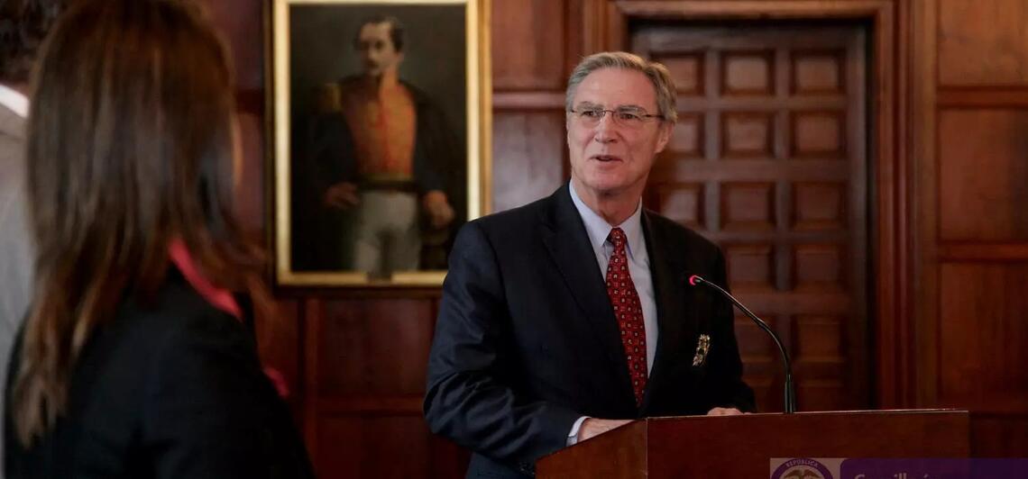 professor emeritus of history Stephen Randall speaking at a lectern.