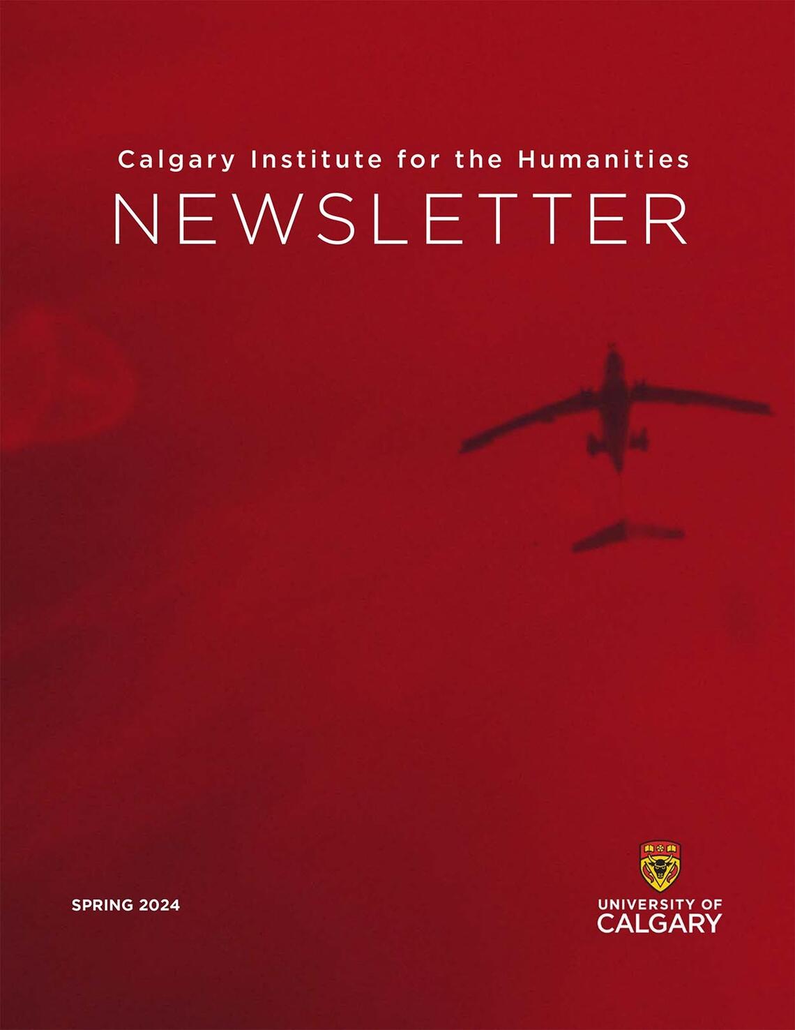 Newsletter cover with blurry silhouette of aircraft flying overhead in a dark red sky