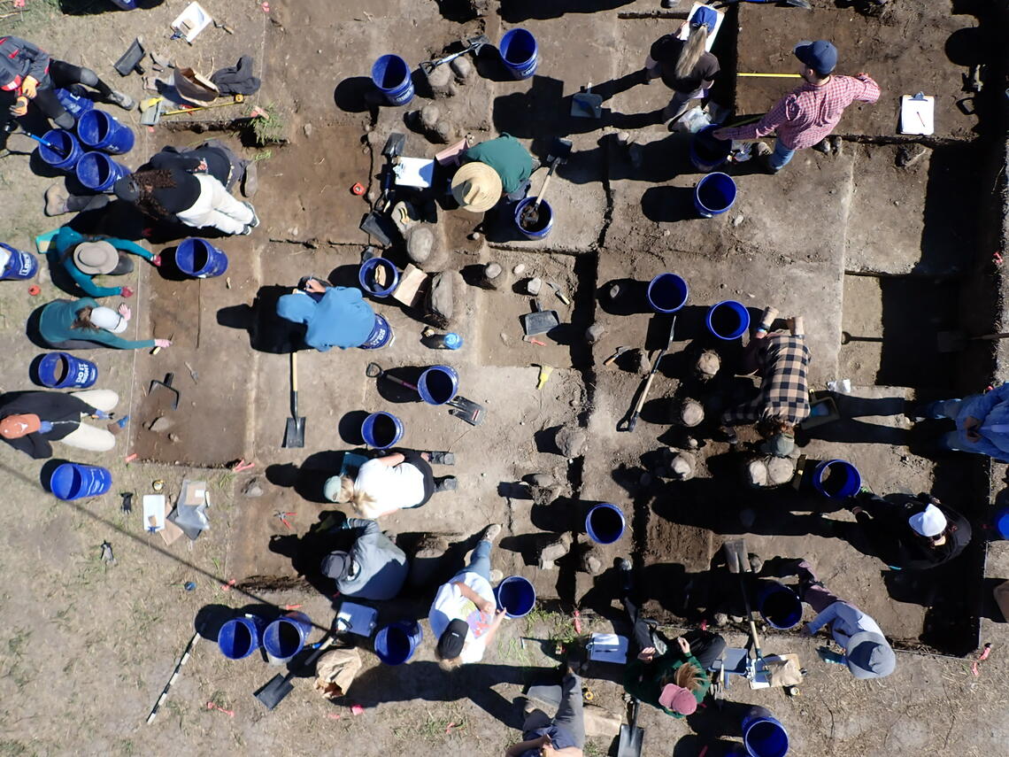 Arial view of archaeological dig site with students