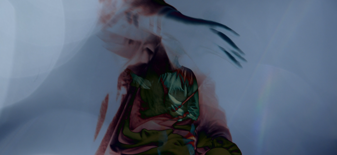 still image from a screendance film. Blurry silhouette of an individual centre screen.