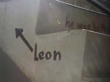 A sideview of stairs with "Leon" and an arrow written on it