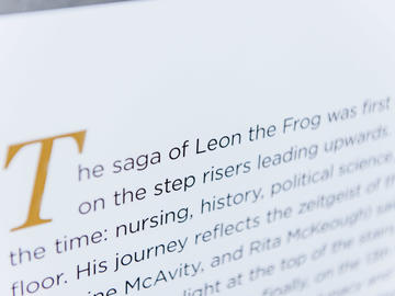 A photo of the Leon the Frog page from The Age of Audacity, a book marking UCalgary's 50th anniversary