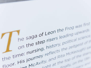 A photo of the Leon the Frog page from The Age of Audacity, a book marking UCalgary's 50th anniversary