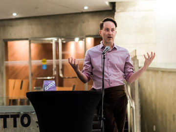 Kevin Allen speaks at the podium