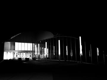 A black and white photo showing the outside of a mall at night