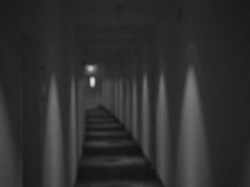 Black and white image of interior apartment hallway