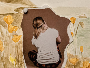 Photo collage of a seated girl facing away from camera. Her picture is ripped and tacked onto a watercoloured landscape