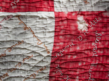 Photograph of weathered red and white surface, signed with different names