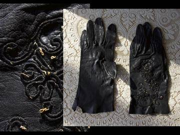 Photograph of gloves on a lace surface, overlaid on a black filligreed object