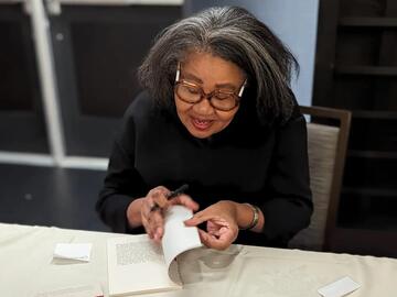 Jamaica Kincaid signs a copy of her book, A Small Place.