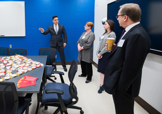 Clinic Director Joshua Madsen shows guests around the space at the opening celebration