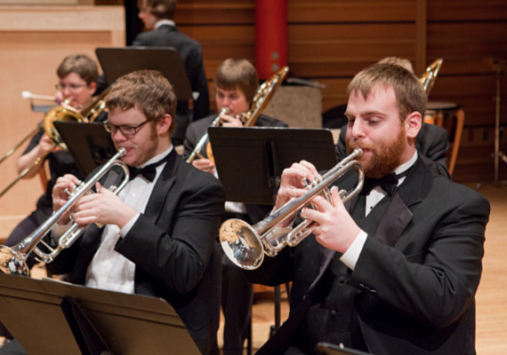 Brass instrument players performing in the Rozsa Centre.