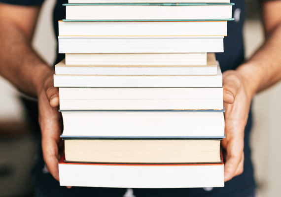 couple of books being held by a person