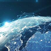 stylized image of earth with network circuitry hovering over globe