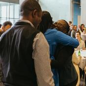 Attendees hugging each other 