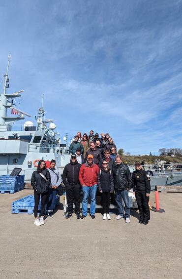 group photo in front of Royal Canadian Navy patrol vessel 