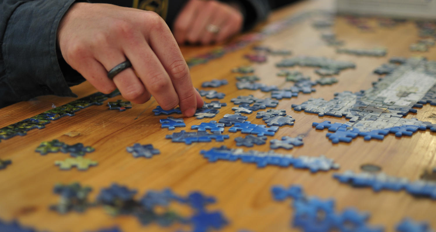 Stock image of a person working on a puzzle